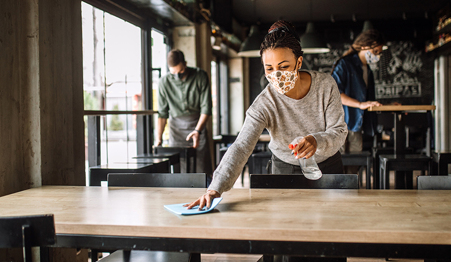 Lady cleaning a table with thymol disinfectant